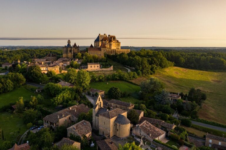 The Château de Biron and its village in the evening light