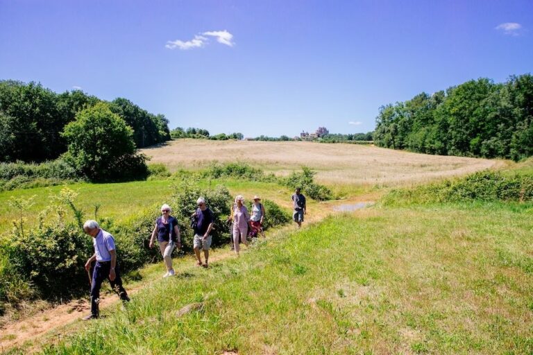 Walkers in the countryside below the Château de Biron
